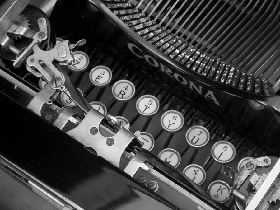 A vintage mechanical typewriter representing the paper’s pre-digital production era